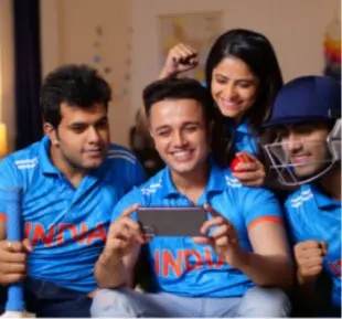 A diverse group of individuals wearing Indian t-shirts are seated on a couch, creating a vibrant atmosphere