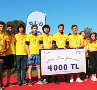 A group of men in the image are dressed in vibrant yellow tshirts, exuding a sense of unity and cheerfulness